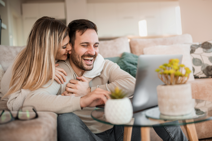 Woman and man in their living room, using a laptop